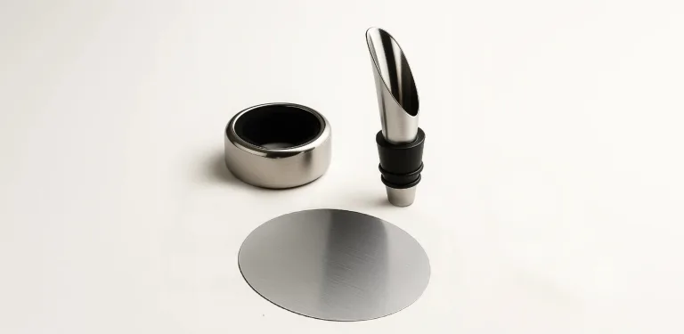 Pouring accessories refine wine service: the spout improves flow, the anti-drip ring protects the bottle and table, and the thin disc drop stopper prevents drips for an elegant, precise presentation.