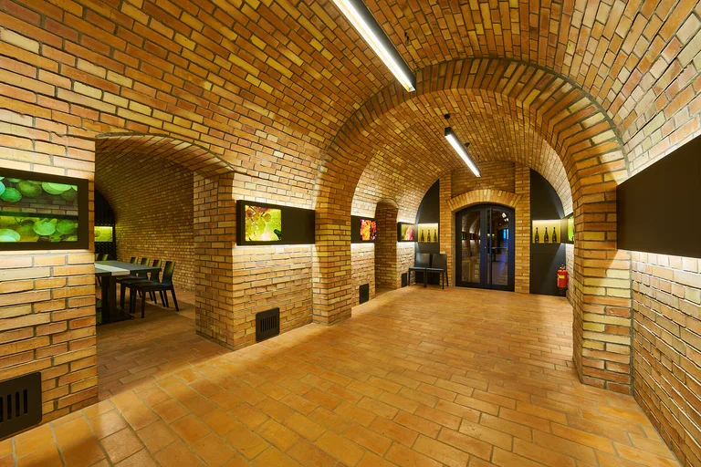 A vaulted brick cellar room set up for tastings