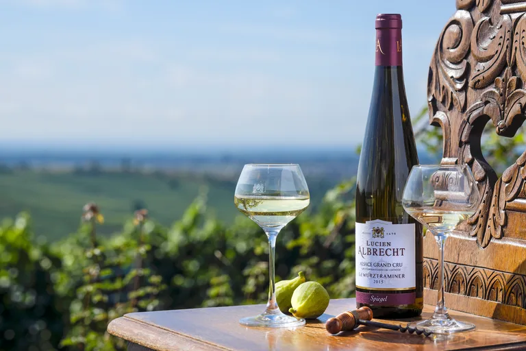 Lucien Albrecht Gewurztraminer Grand Cru, glasses and figs on a terrace table above the vineyards.