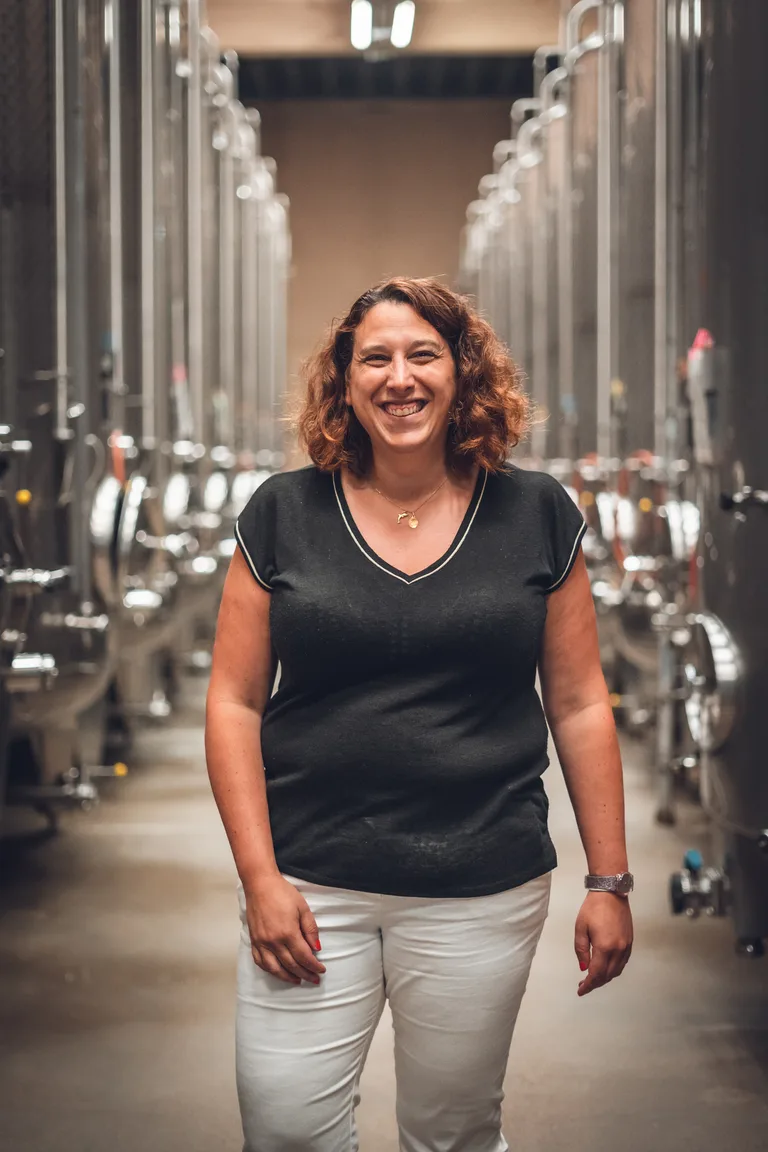 A Wolfberger winemaker among the vats